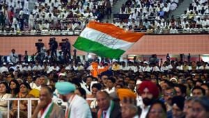 A Congress worker waves a flag during the 84th Plenary Session of The Indian National Congress (INC) at the Indira Gandhi Stadium in New Delhi on Saturday.(PTI) A Congress worker waves a flag during the 84th Plenary Session of The Indian National Congress (INC) at the Indira Gandhi Stadium in New Delhi on Saturday.(PTI)