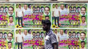 A pedestrian walks past election campaign posters for Karnataka elections 2018 in Bengaluru.(Bloomberg File Photo) A pedestrian walks past election campaign posters for Karnataka elections 2018 in Bengaluru.(Bloomberg File Photo)