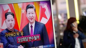 A woman walks past a TV broadcasting a news report on a meeting between North Korean leader Kim Jong Un and Chinese President Xi Jinping in Beijing, in Seoul, South Korea.(Reuters Photo) A woman walks past a TV broadcasting a news report on a meeting between North Korean leader Kim Jong Un and Chinese President Xi Jinping in Beijing, in Seoul, South Korea.(Reuters Photo)