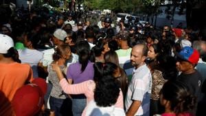 Relatives of inmates at the General Command of the Carabobo Police wait outside the prison in Valencia, Venezuela, on March 28, 2018.(Reuters)