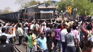Protestors brandishing sticks stop a goods train during in Jaipur on Monday.(HT Photo)