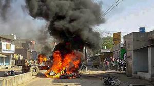 Smoke billows from a burning bus in Alwar on Monday during Bharat Bandh call by Dalit organisations.(PTI photo)