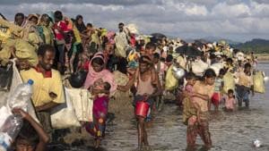 Thousands of Rohingya refugees fleeing from Myanmar walk along a muddy rice field after crossing the border in Palang Khali, Cox's Bazar, Bangladesh.(Getty Images) Thousands of Rohingya refugees fleeing from Myanmar walk along a muddy rice field after crossing the border in Palang Khali, Cox's Bazar, Bangladesh.(Getty Images)