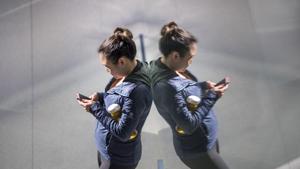 A customer checks her iPhone smartphone store during the sales launch of the Apple Inc. Much more research is obviously needed before we conclude that social media is like tobacco. And even if it is, the harm would need to be very substantial in order to get government policy involved in limiting social-media use.(Bloomberg via Getty Images) A customer checks her iPhone smartphone store during the sales launch of the Apple Inc. Much more research is obviously needed before we conclude that social media is like tobacco. And even if it is, the harm would need to be very substantial in order to get government policy involved in limiting social-media use.(Bloomberg via Getty Images)