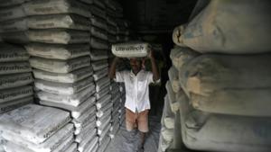 A labourer carries a sack of Ultratech cement inside a shop in Agartala, India.(Reuters File Photo) A labourer carries a sack of Ultratech cement inside a shop in Agartala, India.(Reuters File Photo)