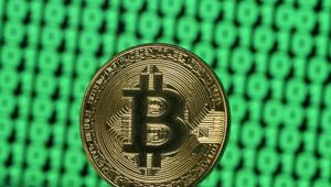 A token of the virtual currency Bitcoin is seen placed on a monitor that displays binary digits in this illustration picture.(Reuters File Photo) A token of the virtual currency Bitcoin is seen placed on a monitor that displays binary digits in this illustration picture.(Reuters File Photo)
