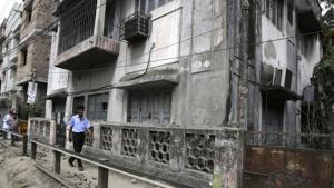 A man walks past the house where Subhabrata Majumdar had allegedly kept his mother's body in a freezer for almost three years in Kolkata.(AP Photo) A man walks past the house where Subhabrata Majumdar had allegedly kept his mother's body in a freezer for almost three years in Kolkata.(AP Photo)