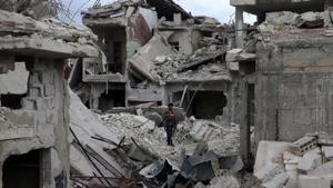 A man stands on rubble of damaged buildings in the besieged town of Douma in Eastern Ghouta.(Reuters) A man stands on rubble of damaged buildings in the besieged town of Douma in Eastern Ghouta.(Reuters)