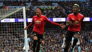 Manchester United's English defender Chris Smalling (L) celebrates scoring their third goal with Paul Pogba (R) during their English Premier League football match against Manchester City at the Etihad Stadium in Manchester, north west England, on Saturday.(AFP) Manchester United's English defender Chris Smalling (L) celebrates scoring their third goal with Paul Pogba (R) during their English Premier League football match against Manchester City at the Etihad Stadium in Manchester, north west England, on Saturday.(AFP)