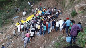 Eyewitnesses said the bus skidded on the road and rolled down the 200-feet deep gorge at Cheli village.(HT Photo) Eyewitnesses said the bus skidded on the road and rolled down the 200-feet deep gorge at Cheli village.(HT Photo)