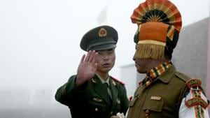 A Chinese soldier gestures to an Indian soldier at the Nathu La border crossing between India and China in Sikkim. Post resolution of the Doklam stand-off, the Chinese Peoples Liberation Army has replaced para-military Peoples Armed Police along the 3,488-kilometre long Line of Actual Control with troops doing training exercises.(AFP File Photo) A Chinese soldier gestures to an Indian soldier at the Nathu La border crossing between India and China in Sikkim. Post resolution of the Doklam stand-off, the Chinese Peoples Liberation Army has replaced para-military Peoples Armed Police along the 3,488-kilometre long Line of Actual Control with troops doing training exercises.(AFP File Photo)