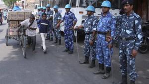 A man carrying goods passes by the Rapid Action Force personnel on duty during ‘Bharat Bandh’ in Jaipur on Tuesday.(Himanshu Vyas/HT) A man carrying goods passes by the Rapid Action Force personnel on duty during ‘Bharat Bandh’ in Jaipur on Tuesday.(Himanshu Vyas/HT)