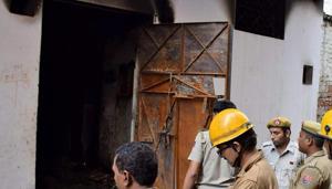 Delhi Fire Service personnel inspect the building of Raja Park factory where a major fire broke out around 6.35 am, in Sultanpuri, New Delhi on Monday.(PTI Photo) Delhi Fire Service personnel inspect the building of Raja Park factory where a major fire broke out around 6.35 am, in Sultanpuri, New Delhi on Monday.(PTI Photo)