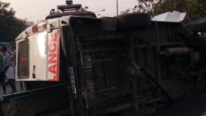 The ambulance toppled after hitting a divider. The ambulance toppled after hitting a divider.