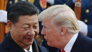 US President Donald Trump talks to Chinese President Xi Jinping during a welcome ceremony at the Great Hall of the People in Beijing last year.(AP File Photo)