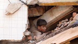 A youth caught in the debris after a building collapsed in Kota on Saturday.(AH Zaidi/HT) A youth caught in the debris after a building collapsed in Kota on Saturday.(AH Zaidi/HT)
