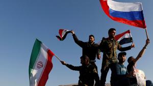 Syrians wave Iranian, Russian and Syrian flags during a protest against U.S.-led air strikes in Damascus,Syria April 14,2018.(REUTERS) Syrians wave Iranian, Russian and Syrian flags during a protest against U.S.-led air strikes in Damascus,Syria April 14,2018.(REUTERS)
