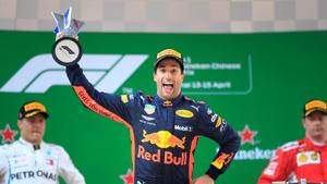 Red Bull Racing's Daniel Ricciardo celebrates on the podium after winning Formula One (F1) Chinese Grand Prix as Mercedes F1 team's Valtteri Bottas and Ferrari's Kimi Raikkonen look on in Shanghai on Sunday.(REUTERS) Red Bull Racing's Daniel Ricciardo celebrates on the podium after winning Formula One (F1) Chinese Grand Prix as Mercedes F1 team's Valtteri Bottas and Ferrari's Kimi Raikkonen look on in Shanghai on Sunday.(REUTERS)