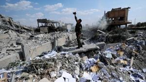 A Syrian soldier on Saturday films the damage of the Syrian Scientific Research Centre which was attacked by US, British and French military strikes to punish President Bashar Assad for suspected chemical attack against civilians.(AP) A Syrian soldier on Saturday films the damage of the Syrian Scientific Research Centre which was attacked by US, British and French military strikes to punish President Bashar Assad for suspected chemical attack against civilians.(AP)