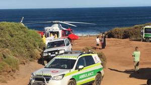 A rescue helicopter and other emergency vehicles are seen at the scene of the shark attack in Gracetown, Australia, Monday.(AP Photo) A rescue helicopter and other emergency vehicles are seen at the scene of the shark attack in Gracetown, Australia, Monday.(AP Photo)