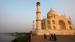 Tourists walk in front of the historic Taj Mahal in Agra.(Reuters File Photo) Tourists walk in front of the historic Taj Mahal in Agra.(Reuters File Photo)