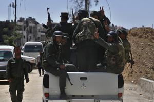 Syrian police units wave and give the victory sign as they patrol in the town of Douma, the site of a suspected chemical weapons attack, near Damascus.(AP) Syrian police units wave and give the victory sign as they patrol in the town of Douma, the site of a suspected chemical weapons attack, near Damascus.(AP)
