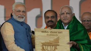 PM Narendra Modi presents a memento to Karnataka state BJP leader BS Yeddyurappa during 'Parivarthana Rally' in Bangalore on February 4, 2018.(AFP File Photo) PM Narendra Modi presents a memento to Karnataka state BJP leader BS Yeddyurappa during 'Parivarthana Rally' in Bangalore on February 4, 2018.(AFP File Photo)
