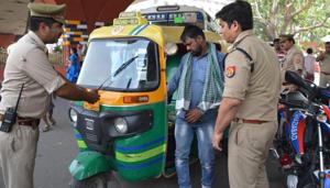 Police officials stop an autorickshaw driver at a checkpost in Ghaziabad on Thursday. The large-scale crackdown caught several auto drivers unawares and they quickly suspended operations, leaving commuters waiting for long to reach their destinations.(Sakib Ali /HT Photo) Police officials stop an autorickshaw driver at a checkpost in Ghaziabad on Thursday. The large-scale crackdown caught several auto drivers unawares and they quickly suspended operations, leaving commuters waiting for long to reach their destinations.(Sakib Ali /HT Photo)