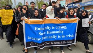 Lawyers and students hold placards during a protest demanding justice for 8-year-old Asifa who was raped and murdered in Kathua, in Srinagar on Wednesday.(PTI Photo)