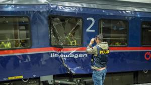 A policemen takes pictures of a demolished couchette car standing on a platform after two train carriages collided at the main railway station in Salzburg,(AFP) A policemen takes pictures of a demolished couchette car standing on a platform after two train carriages collided at the main railway station in Salzburg,(AFP)