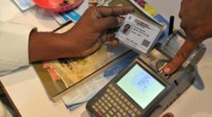 A visitor gives a thumb impression to withdraw money from his bank account with his Aadhaar or Unique Identification (UID) card during a Digi Dhan Mela.(AFP File Photo)