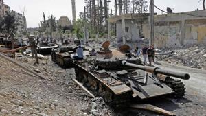 Destroyed tanks and armoured personnel carriers are pictured on a road in the Eastern Ghouta town of Douma on the outskirts of the capital Damascus on April 20, 2018, during an army-organised media tour.(AFP Photo) Destroyed tanks and armoured personnel carriers are pictured on a road in the Eastern Ghouta town of Douma on the outskirts of the capital Damascus on April 20, 2018, during an army-organised media tour.(AFP Photo)