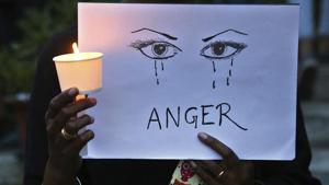 A woman holds a candle and placard seeking an end to sexual violence against women, which has been on the rise in the country, during a protest in Bangalore.(AP Photo) A woman holds a candle and placard seeking an end to sexual violence against women, which has been on the rise in the country, during a protest in Bangalore.(AP Photo)