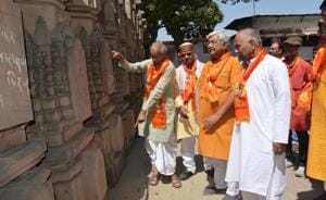 Newly-elected VHP chief Vishnu Sadashiv Kokje(extreme left) observing the stone pillars for the proposed Ram Mandir at VHP’s workshop in Ayodhya.(HT Photo)