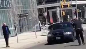 Video footage showed the police officer staring down the suspect at gunpoint in the middle of a street, while the man pointed what appeared to be a gun and shouted “Kill me.”(Youttube Screenshot) Video footage showed the police officer staring down the suspect at gunpoint in the middle of a street, while the man pointed what appeared to be a gun and shouted “Kill me.”(Youttube Screenshot)