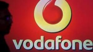 A man casts silhouette onto an electronic screen displaying logo of Vodafone India in Mumbai.(Reuters File) A man casts silhouette onto an electronic screen displaying logo of Vodafone India in Mumbai.(Reuters File)