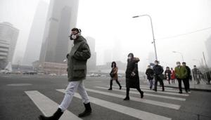 A man wearing a respiratory protection mask walks toward an office building during the smog after a red alert was issued for heavy air pollution in Beijing's central business district, China.(Reuters File Photo) A man wearing a respiratory protection mask walks toward an office building during the smog after a red alert was issued for heavy air pollution in Beijing's central business district, China.(Reuters File Photo)
