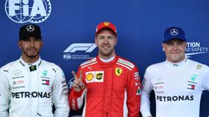 Pole position winner Ferrari's German driver Sebastian Vettel (C) celebrates with second placed Mercedes' British driver Lewis Hamilton (L) and third placed Mercedes' Finnish driver Valtteri Bottas after the qualifying session for the Formula One Azerbaijan Grand Prix at the Baku City Circuit in Baku on Saturday.(AFP) Pole position winner Ferrari's German driver Sebastian Vettel (C) celebrates with second placed Mercedes' British driver Lewis Hamilton (L) and third placed Mercedes' Finnish driver Valtteri Bottas after the qualifying session for the Formula One Azerbaijan Grand Prix at the Baku City Circuit in Baku on Saturday.(AFP)