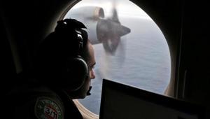 Flight officer Rayan Gharazeddine looks out of a Royal Australian Air Force (RAAF) AP-3C Orion as it flies over the southern Indian Ocean during the search for missing Malaysian Airlines flight MH370 March 22, 2014.(Reuters File Photo) Flight officer Rayan Gharazeddine looks out of a Royal Australian Air Force (RAAF) AP-3C Orion as it flies over the southern Indian Ocean during the search for missing Malaysian Airlines flight MH370 March 22, 2014.(Reuters File Photo)