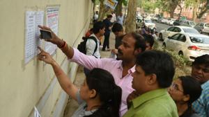 Students and parents check the seating plan schedule for the NEET exam at Kerala School in New Delhi.(Sushil Kumar/HT Photo) Students and parents check the seating plan schedule for the NEET exam at Kerala School in New Delhi.(Sushil Kumar/HT Photo)