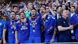 Cardiff City manager Neil Warnock, Sol Bamba, Gary Madine and team mates with the trophy as they celebrate promotion to the Premier League.(REUTERS) Cardiff City manager Neil Warnock, Sol Bamba, Gary Madine and team mates with the trophy as they celebrate promotion to the Premier League.(REUTERS)