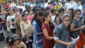Applicants wait outside an examination centre to appear in the National Eligibility-Cum-Entrance Test 2018, in Jabalpur on Sunday.(PTI)