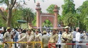 Security personnel stand guard as Aligarh Muslim University students stage a protest over Jinnah portrait issue outside the university gate in Aligarh.(PTI file photo) Security personnel stand guard as Aligarh Muslim University students stage a protest over Jinnah portrait issue outside the university gate in Aligarh.(PTI file photo)