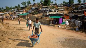 A Rohingya refugee carries bricks to rebuild his makeshift house, in preparation for the approaching monsoon season at the Kutupalong Rohingya refugee camp in Bangladesh.(AP Photo) A Rohingya refugee carries bricks to rebuild his makeshift house, in preparation for the approaching monsoon season at the Kutupalong Rohingya refugee camp in Bangladesh.(AP Photo)