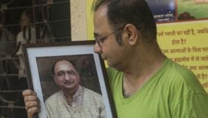Atul Date, son of late Arun Date, holds his father’s photo outside Sion crematorium on Sunday.(Pratik Chorge) Atul Date, son of late Arun Date, holds his father’s photo outside Sion crematorium on Sunday.(Pratik Chorge)