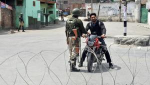 Security personnel stop a bike rider during curfew-like restrictions imposed to maintain law and order in Srinagar on Sunday. The authorities have put up barricades as well as concertina wires across the city in view of a protest march called by separatists.(PTI Photo) Security personnel stop a bike rider during curfew-like restrictions imposed to maintain law and order in Srinagar on Sunday. The authorities have put up barricades as well as concertina wires across the city in view of a protest march called by separatists.(PTI Photo)