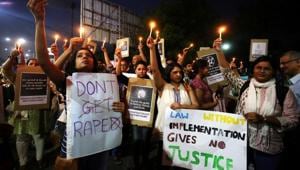 People hold candles and placards during a protest against the rape of an eight-year-old girl in Kathua.(Reuters File Photo) People hold candles and placards during a protest against the rape of an eight-year-old girl in Kathua.(Reuters File Photo)