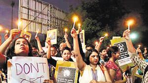 People hold candles and placards during a protest against the recent rape cases in the country, in Surat, Gujarat.(Reuters file photo) People hold candles and placards during a protest against the recent rape cases in the country, in Surat, Gujarat.(Reuters file photo)