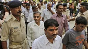 Policemen escort men charged for involvement in the 2002 riots at Ode village into the district court in Anand, Gujarat.(AP File Photo) Policemen escort men charged for involvement in the 2002 riots at Ode village into the district court in Anand, Gujarat.(AP File Photo)