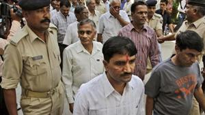 Policemen escort men charged for involvement in the 2002 riots at Ode village into the district court in Anand, Gujarat.(AP File Photo) Policemen escort men charged for involvement in the 2002 riots at Ode village into the district court in Anand, Gujarat.(AP File Photo)